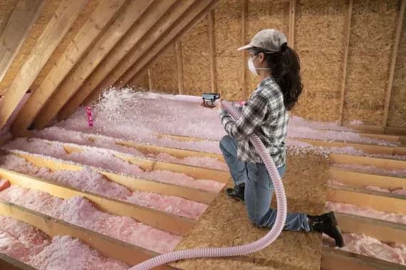 6696b2e56cd8185b326ef775_woman-blown-in-attic-insulation__ScaleMaxWidthWzU3MF0.webp